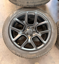Load image into Gallery viewer, Set of 4 Used Black '19-'26 RAM 1500 22" Wheels 285/45R22 Pirelli All Season LT