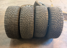 Load image into Gallery viewer, Set of Used '19-'26 RAM 1500 TRX Black OEM Wheels 325/65R18 Goodyear AT Tires LT