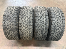 Load image into Gallery viewer, Set of 4 Used OEM '05-'26 RAM 2500 Power Wagon Wheels on 285/70R17 BFGoodrich AT