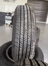 Load image into Gallery viewer, OEM '07-'26 Jeep Wrangler 17" Dark Charcoal Rims 245/75R17 Bridgestone HT Tires
