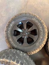 Load image into Gallery viewer, Set of Used '19-'26 RAM 1500 Black Rims 275/70R18 Goodyear Wrangler Duratrac LT