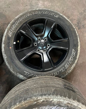 Load image into Gallery viewer, Set of 4 Used '19-'26 RAM 1500 Black OEM Wheels 275/55R20 Bridgestone H/L OWL LT