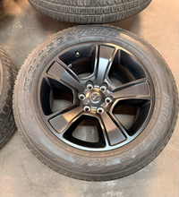 Load image into Gallery viewer, Set of Used 20" Matte Black '19-'26 RAM 1500 OEM Wheels 275/55R20 Bridgestone LT

