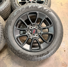 Load image into Gallery viewer, Set of Used '22-'26 Toyota Tundra OEM TRD Black Wheels on 265/60R20 Falken AT LT
