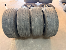 Load image into Gallery viewer, Set of Used 20" Matte Black '19-'26 RAM 1500 OEM Wheels 275/55R20 Bridgestone LT
