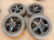 Load image into Gallery viewer, Set of Used 20" Matte Black '19-'26 RAM 1500 OEM Wheels 275/55R20 Bridgestone LT

