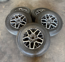 Load image into Gallery viewer, OEM '07-'26 Jeep Wrangler 18" Used Wheels on 255/70R18 Bridgestone HT Tires LT
