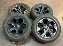 Load image into Gallery viewer, OEM '19-'26 RAM 1500 Matte Black 20" Used Wheels 275/55R20 Bridgestone Tires  LT
