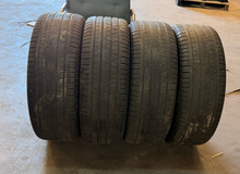 Load image into Gallery viewer, Set of 4 Used Black '19-'26 RAM 1500 22" Wheels 285/45R22 Pirelli All Season LT
