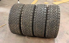 Load image into Gallery viewer, Set of Used '00-'26 GMC Sierra 1500 AT4 18" OEM Wheels 265/65R18 BFG AT TAKO2 LT
