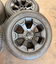 Load image into Gallery viewer, Set of Used 20" '19-'26 RAM 1500 Matte Black Wheels on 275/55R20 Bridgestone LT
