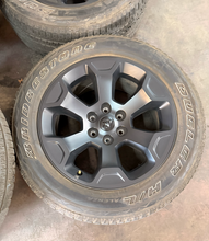 Load image into Gallery viewer, Set of Used 20" '19-'26 RAM 1500 2462 Black Clad Wheels 275/55R20 Bridgestone LT
