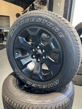 Load image into Gallery viewer, Set of Four OEM Black &#39;19-&#39;25 RAM 1500 Wheels 275/55R20 Bridgestone Alenza Tires
