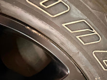 Load image into Gallery viewer, Set of Used 20" Black '19-'26 RAM 1500 2676 Wheels 275/55R20 Bridgestone H/L LT
