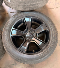 Load image into Gallery viewer, Set of Used 20" Black '19-'26 RAM 1500 2676 Wheels 275/55R20 Bridgestone H/L LT
